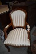A reproduction upholstered carver chair