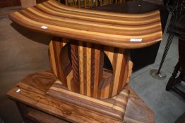 An Oriental style mixed wood stool or occasional table