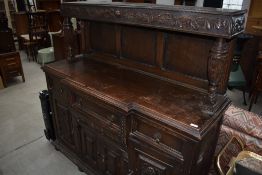 A Late Victorian sideboard in the court cupboard style having carved and pokerwork decoration, width