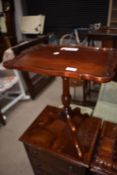 A reproduction mahogany occasional/wine table