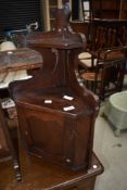 A small corner cupboard, with key