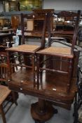 A pair of Victorian mahogany bedroom chairs having cane seats and a single cane seated bedroom