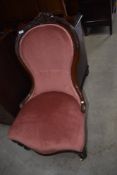 A 19th Century mahogany framed nursing chair having baloon back and pink dralon nursing chair