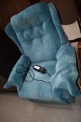 A modern electric recliner having teal upholstery
