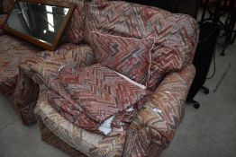 A vintage three piece suite and pair of matching curtains