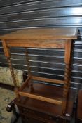 An early 20th Century oak occasional table having twist leg