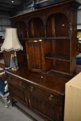A late 19th/early 20th Century oak dresser having linen fold decoration to doors, width approx.