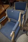 A pair of painted French style scroll armchairs