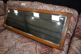 A full length wall mirror, probably from a wardrobe, but now with mounts for landscape orientation ,