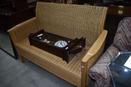 A modern beech and wicker settee, approx width 134cm