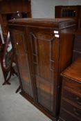 An early 20th Century oak bookcase with leaded glass doors , key included