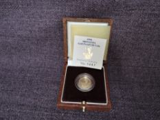 A 1995 Queen Elizabeth II 1/10 oz 10 Pound Gold Proof Britannia Coin, in original box with