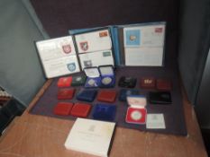 A collection of mainly cased Silver Coins, mainly crown sized, GB and World, 16 cased Coins,