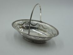 A Georgian silver sweetmeat basket of boat form having pierced and bright cut decoration, beaded