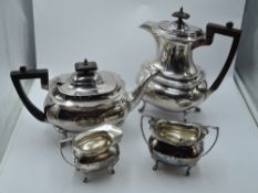 A four piece silver tea set of ovoid form having paw feet, soft wood handles, bear arm crest to