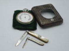 Two folding fruit knives with mother of pearl handles and HM silver blades, and a travel watch