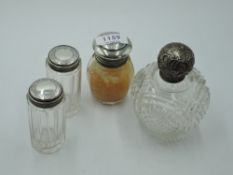 Four assorted glass dressing table pots having HM silver lids, including cut glass scent bottle (