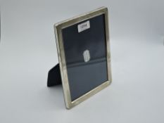 A silver photograph frame of plain rectangular form having navy velvet easel stand, Sheffield