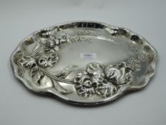A silver dressing table tray of shaped oval form having Art Nouveau style repousse floral