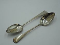 A pair of Georgian silver table spoons of Old English form bearing monogram to terminals, London
