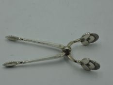 A pair of Danish silver sugar nips by Georg Jensen in the cactus pattern, bearing marks re 1910-