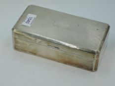 A silver cigarette box having engine turned decoration and plain cartouche, Birmingham 1955, Adie