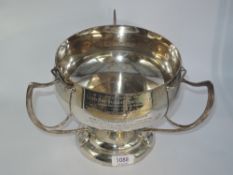 A silver trophy cup of Art Nouveau form having trefoil stylised handles and presentation inscription
