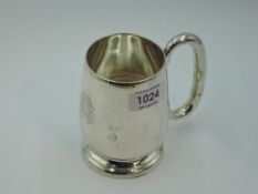 A silver tankard having moulded loop handle, engraved monogram and pedestal foot, Birmingham 1933,