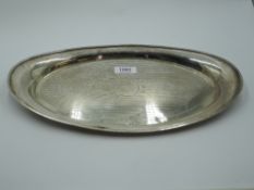 A silver tray of oval form having engine turned decoration and plain cartouche, Birmingham 1915, F H