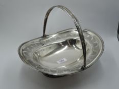 A Georgian silver table basket having leaf and scallop shell etched decoration and swing handle,