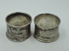 A pair of German silver napkin rings having engraved floral decoration and German inscription,