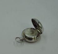 A silver sovereign holder of plain circular pebble form, Birmingham 1910, Aaron Lufkin Dennison,
