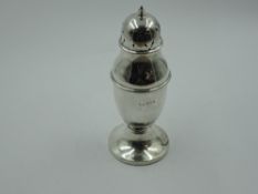 A silver sugar caster of urn form having push on pierced lid and weighted pedestal base,