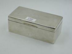 A silver cigarette box of plain rectangular form bearing monogram to lid, Birmingham 1934, William