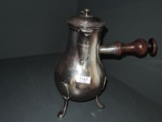 A European silver plated chocolate pot of baluster form having turned wooden handle and trefoil