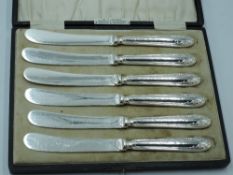 A cased set of six silver handled butter knives having moulded decoration, Sheffield 1911, C W