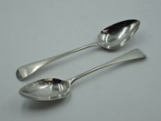 A pair of Georgian silver table spoons of Old English form bearing monogram to terminals, London