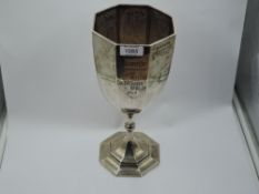 An Edwardian silver oversized trophy cup of octagonal goblet form bearing presentation
