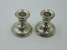 A pair of silver candle sticks of short form having removable sconces, Birmingham 1972, S J Rose &