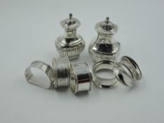 Five HM silver napkin rings of various forms and a matched pair of HM silver pepperettes, approx