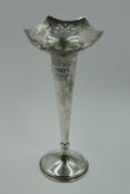 A silver trumpet vase having pierced decoration to shaped rim, tapered stem and weighted base,