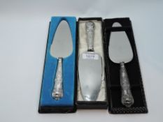 Three cased HM silver handled cake slices in the kings pattern