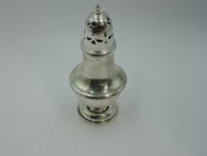 A silver sugar caster of waisted baluster form having pierced push on lid, Birmingham 1913, S
