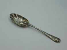 A Georgian silver berry spoon having gilt wash to fluted bowl with berry decoration, moulded