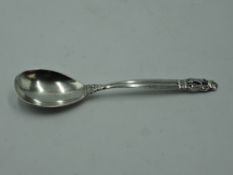 A Danish silver dessert spoon by Georg Jensen in the acorn pattern, bearing 1930's import mark,