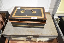 A deed box and a vintage petty cash tin or similar.