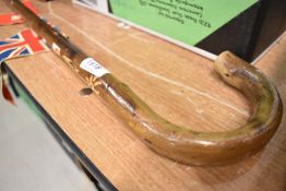 A vintage walking cane or pole having floral carving,flag and Switzerland sticker.