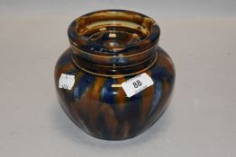 A large 19th century bulbous earthen ware tobacco jar having blue and brown mottled glaze.AF