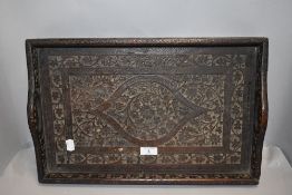 An early 20th century carved mahogany tray of Eastern design.