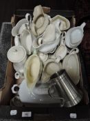 A selection of cream jugs and gravy boats of various designs in white glazes